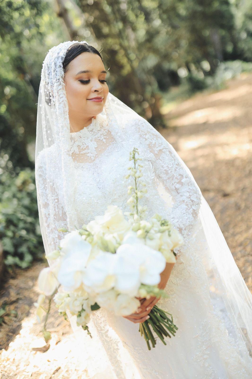 Bride in a beaded gown and veil in a Cape Town garden