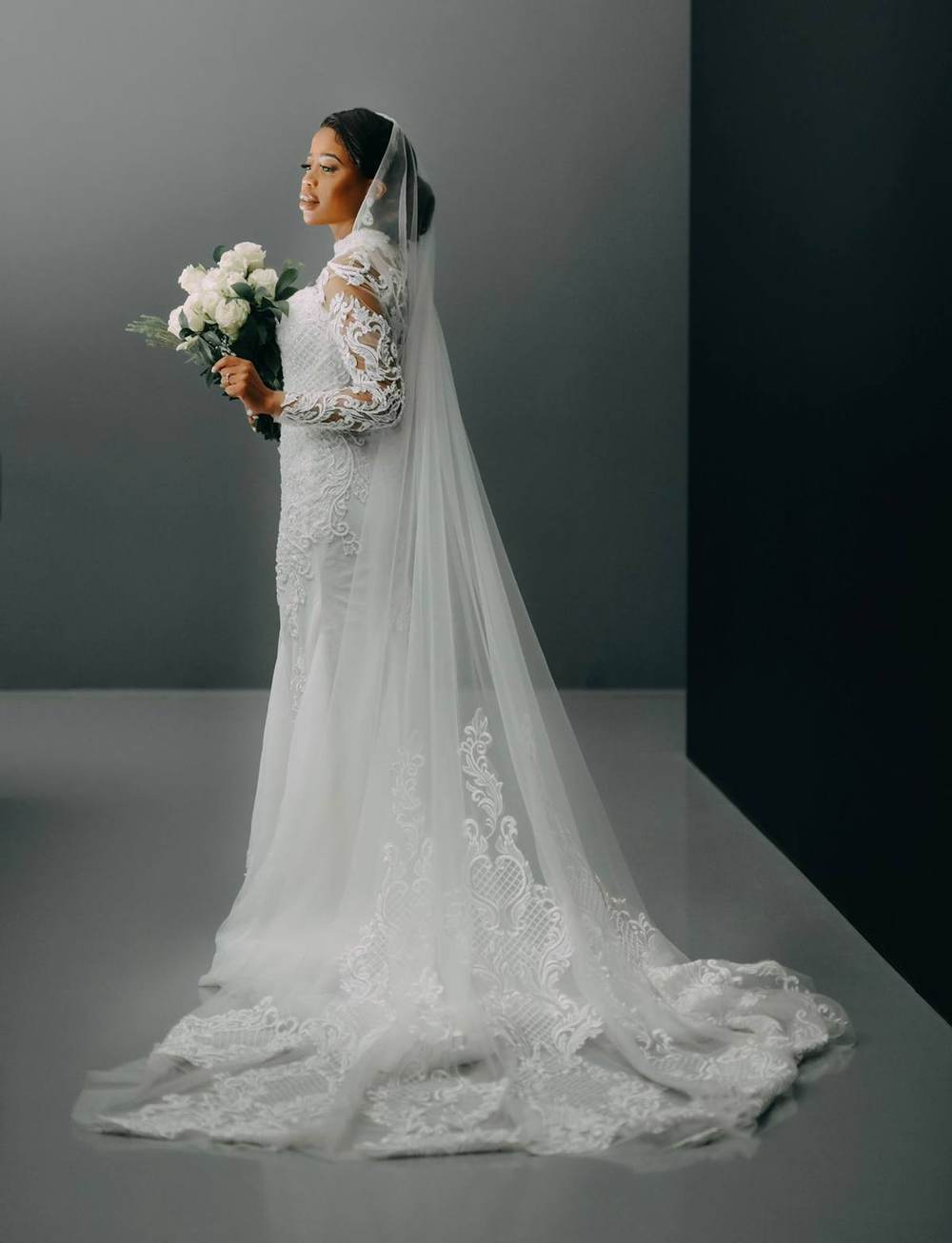 Bride in a fitted lace gown with a cathedral train by Saarahjasmin Couture