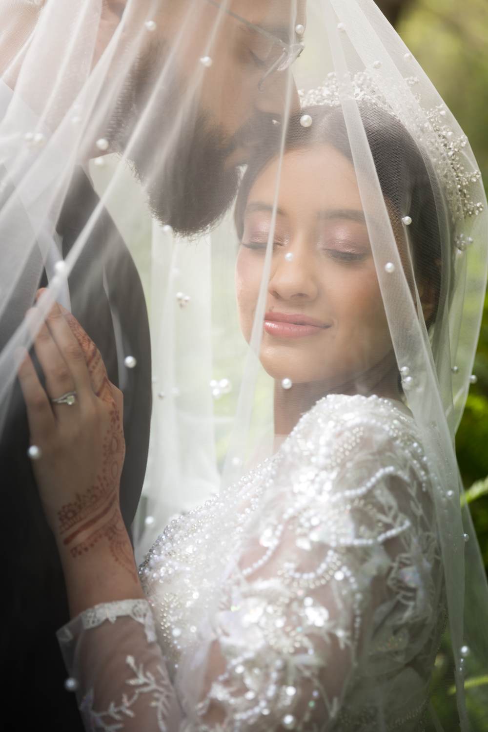 Bride holding her veil in a quiet moment before her ceremony